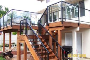 Combination of aluminum picket stair railings and glass patio railings by Castle Decks & Aluminum Products.
