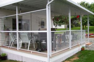 Combination of picket and glass deck railings with aluminum cover and vinyl decking